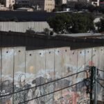 ‘Ik ben beide benen verloren’: Palestijnen beklimmen afscheidingsmuur voor kans op werk